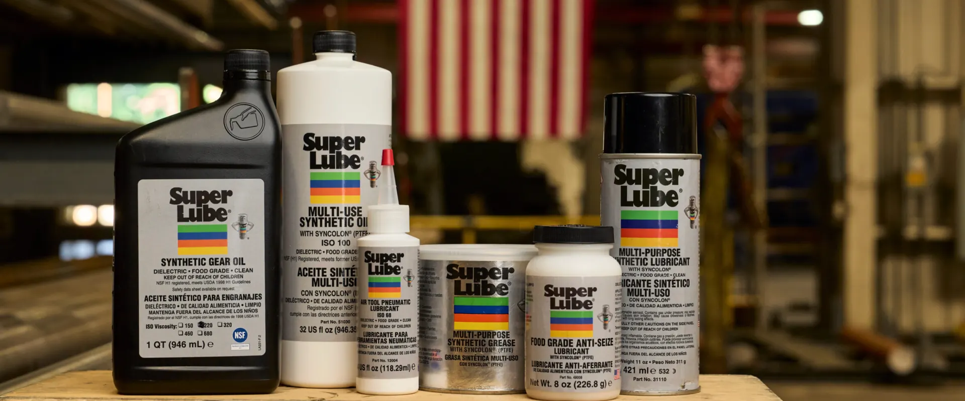 Super Lube synthetic oils, greases and aerosol lubricants on a workshop bench